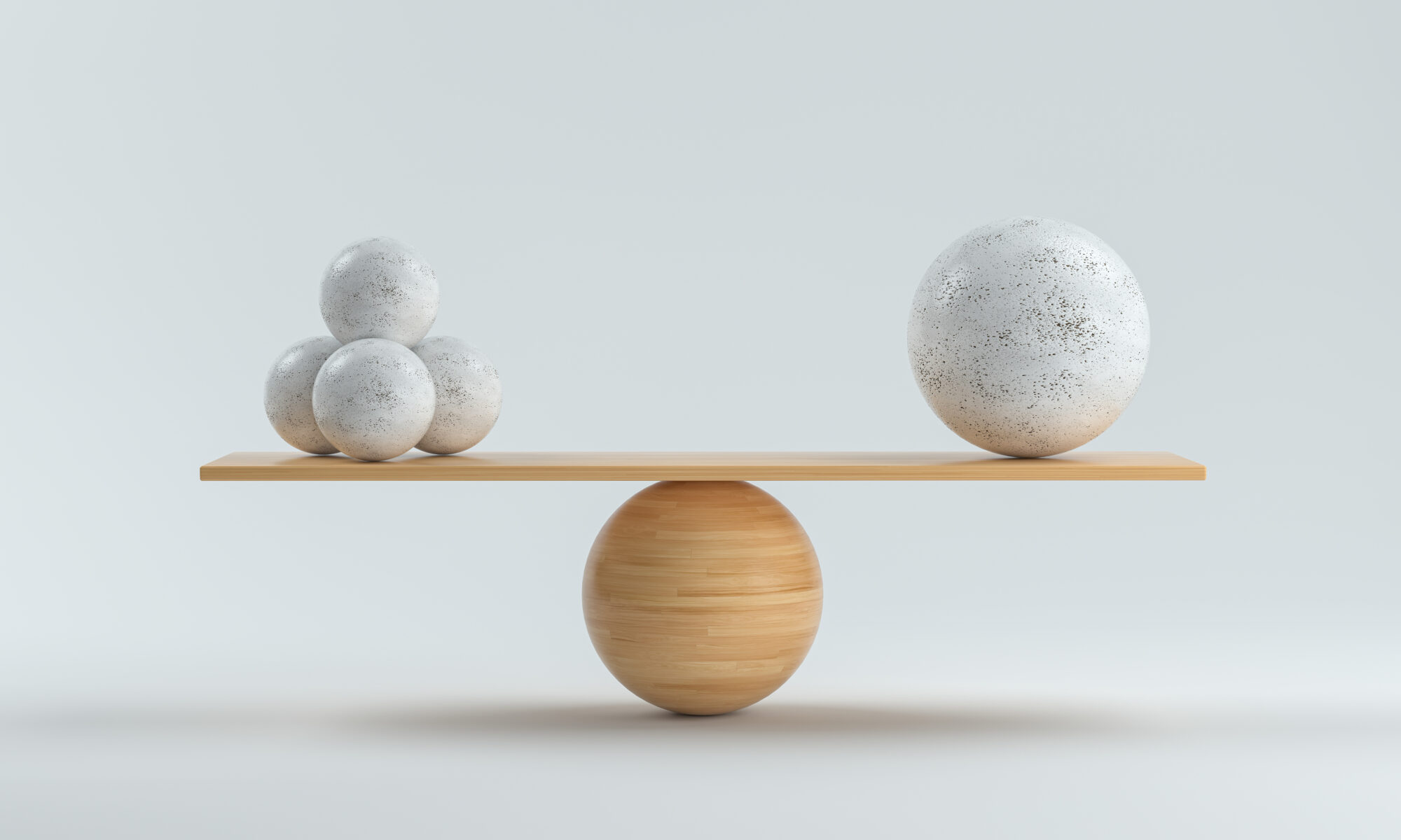 wooden scale balancing one big ball and four small ones